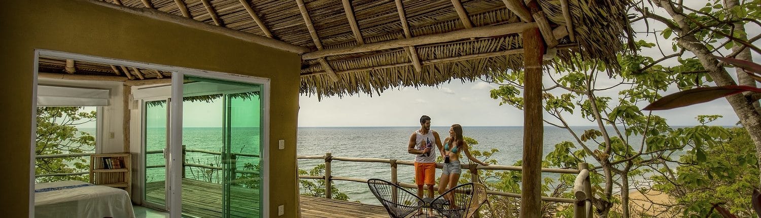 Young couple on hotel room balcony in View of Flamingos from the beach in Riviera Nayarit Mexico