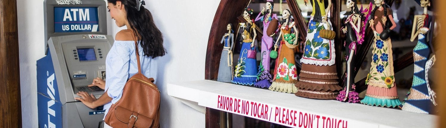 Local services in Riviera Nayarit - Woman at ATM machine beside Day of the Dead window display