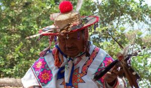 Huichol man dressed in colorful costume